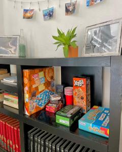 a shelf filled with books and othercellaneous items at The Boat House Cancun in Cancún