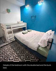 a bedroom with a bed and a blue wall at Modern Family Apartment 20mins from Disney / 45mins from Paris in Lognes