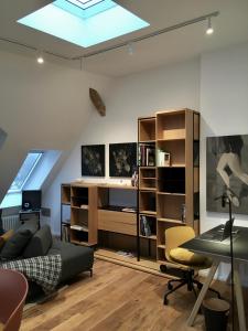 a living room with a couch and a desk at RaumAusbeute Design Apartment Hoher Priester in Detmold