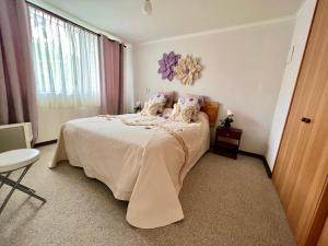 a bedroom with a large bed and a window at Espectacular Depto en Pucon 5 Estrellas in Pucón