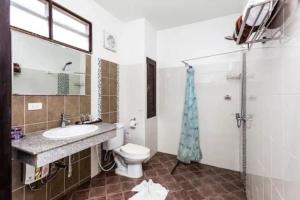 a bathroom with a toilet and a sink and a shower at Monaburi Boutique Resort in Rawai Beach