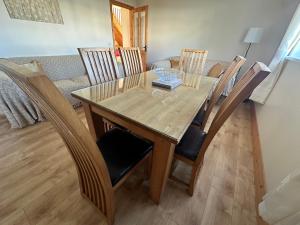 a dining room table with chairs and a couch at House in Glenties in Glenties