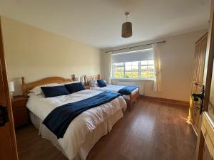 a bedroom with two beds and a window at House in Glenties in Glenties