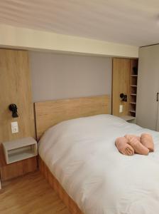 a bedroom with a bed with two towels on it at Minimal Two-Floor Apartment in Thessaloniki