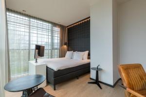 Postel nebo postele na pokoji v ubytování Leonardo Hotel Groningen