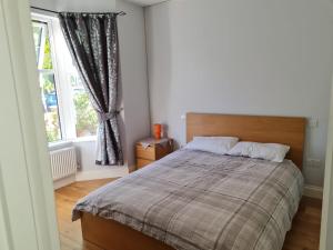 a bedroom with a large bed and a window at Daniari guest rooms in Erith