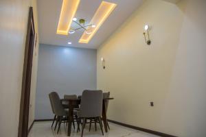 a dining room with a table and chairs at Lake Luxury Homes in Ibadan