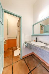 a bathroom with a sink and a mirror at Hotel Flor de Maria in Puerto Escondido