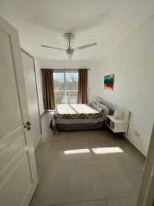 a bedroom with a bed and a window at Antonia in Villa Elisa