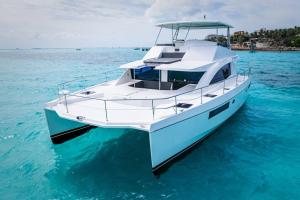 a white and blue boat in the water at All Inclusive Luxury Yacht with Private Island in Cancún