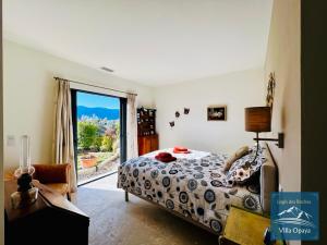 a bedroom with a bed and a sliding glass door at LOGIS DES ROCHES - 2 VILLAS VUE EXCEPTIONNELLE - Le Petit Chevalet, Le Grand Sabouillon in Buis-les-Baronnies +148 photos