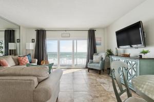 a living room with a view of the ocean at Sunrise at the Beach - 2BR Apt with Scenic Views in Satellite Beach