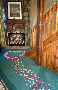 a room with a fireplace with a heart on the floor at Hideaway Country Inn in Bucyrus