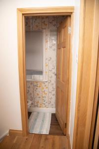 an open door into a bathroom with a toilet at Guest house in Wythenshawe