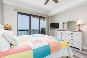 a bedroom with a bed with a view of the ocean at Grand Pointe Unit 506 in Orange Beach