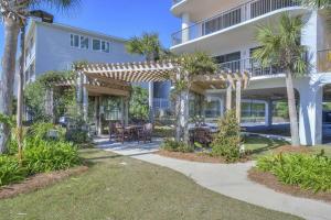a house with a pergola and a patio at Grand Pointe Unit 506 in Orange Beach