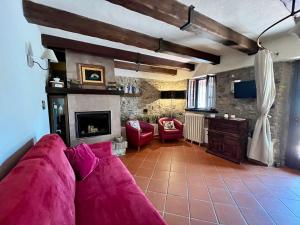 a living room with a pink couch and a fireplace at Villa Daniela in Camaiore
