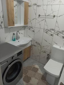 a bathroom with a washing machine and a sink at Dilaver-Apart in Istanbul