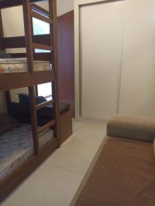 a room with a bunk bed and a mirror at Praia de Palmas in Governador Celso Ramos
