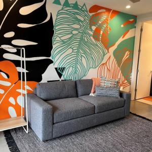 a living room with a couch in front of a mural at Perfect Friends Escape in Old Town Scottsdale with Resort Pool Access and Roof Deck! in Scottsdale