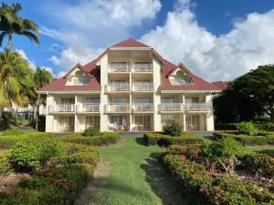 a large building with a garden in front of it at Karibbean Resort in Sainte-Luce