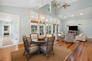 a dining room with a table and chairs at 1002 E Cooper The Folly Peach Beautiful Spacious House Steps from the beach in Folly Beach