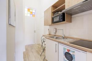 a kitchen with a sink and a microwave at Cozy & 3 minutes from main square - J in Zagreb +7 photos