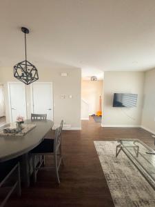 a dining room with a table and chairs in a room at Entire house to yourselves - NO basement sharing in Regina