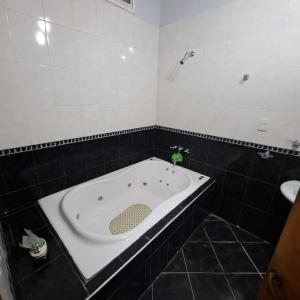 a bathroom with a bath tub with a sink at MIA & ZOE in Malargüe