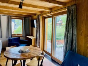 a living room with a table and a large window at Harrachov 702 in Harrachov