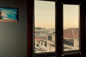 a view of a city from a window at Private Studio Loft w. Bosphorus view near Galata in Istanbul