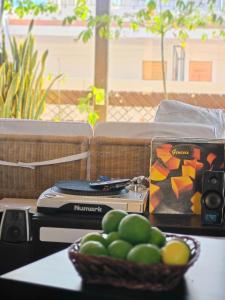 a table with a bowl of fruit on a couch at Casa Compartida Weyler in Santa Cruz de Tenerife