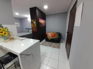 a living room with a table and a couch at Flat Palladium in São Vicente