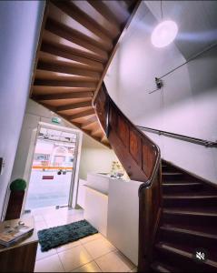 a staircase in a room with a door and a stair case at Hotel Real Koerich 24h in Rio do Sul