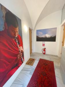 a monk playing a clarinet in a room with a painting at Cozy Dachsberg in Krems an der Donau