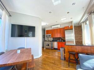 a kitchen with a wooden table and a counter top at Gorgeous Three Bedroom West Village Townhouse in New York