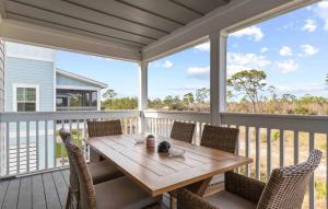 a porch with a wooden table and chairs at Paradise Key at Lost Key Golf & Beach Club in Pensacola