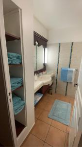 a bathroom with a sink and a mirror and a sink at Karibbean Resort in Sainte-Luce