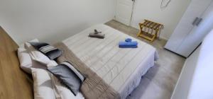 a bedroom with a large bed with two slippers on it at Maras Rental #4 in Río Grande