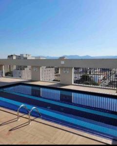 a swimming pool on top of a building at Flat Palladium in São Vicente