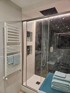 a bathroom with a shower and a glass shower stall at Il Giardino di Iris in Genova