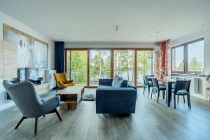 a living room with a couch and chairs and a table at Stacja Mazury(Masuria Station) in Narty