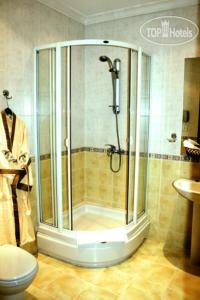 a shower with a glass door in a bathroom at Swan Hotel Baku in Baku