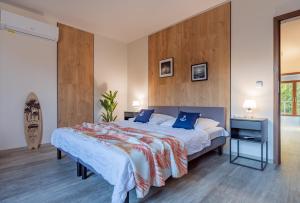 a bedroom with a large bed with blue pillows at Stacja Mazury(Masuria Station) in Narty