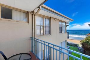 a balcony of a house with a view of the ocean at Golden Sands Apartment 10 in The Entrance