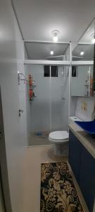 a bathroom with a shower with a toilet and a sink at Apartamento aconchegante em Itajaí in Itajaí