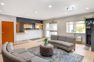 a living room with two couches and a table at Best Western Kokomo Hotel in Kokomo