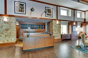 a lobby of a hotel with a stone wall at Drury Inn & Suites San Antonio Airport in San Antonio