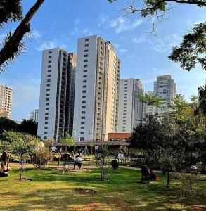 a park with tall buildings in a city at Laguna Linda Vista in São Paulo