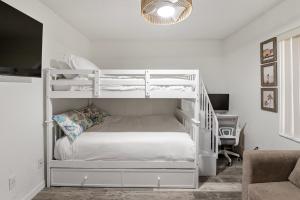 a bedroom with white bunk beds and a desk at Villa Maria Salt Sun 7 minutes to Indian Rocks Beach in Largo +41 photos
